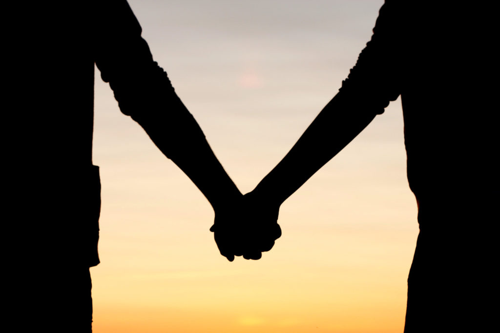 Holding hands in sunset