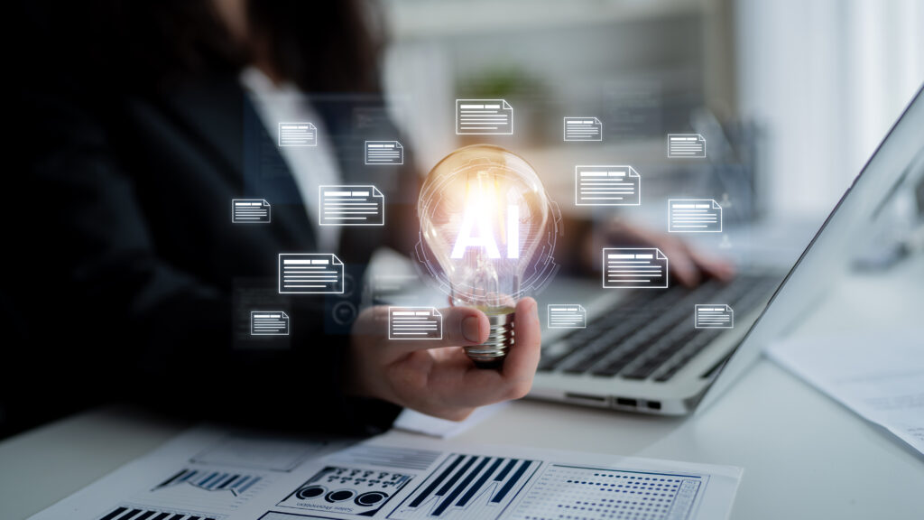 Person holding lightbulb that reads "AI" with digital documents around it.
